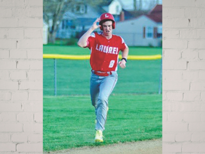 Baseball player in a red uniform with helmet, number 8, running on the infield with a raised arm gesture as he celebrates.
