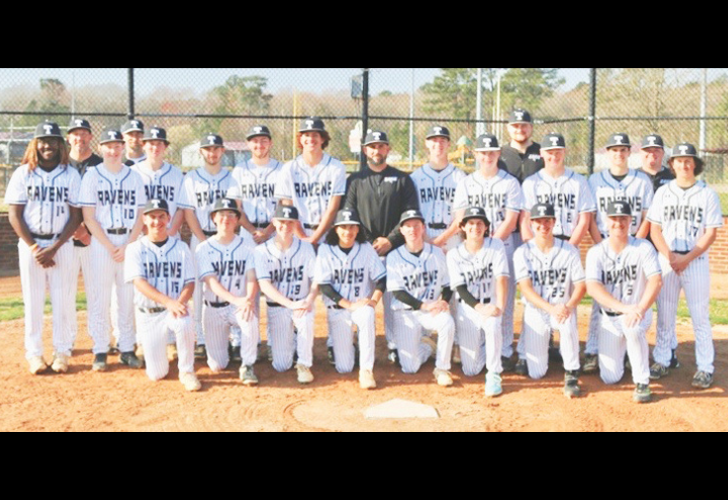 Baseball team group photo on the infield, players in white uniforms with 'RAVENS' and black caps, coaches standing behind.